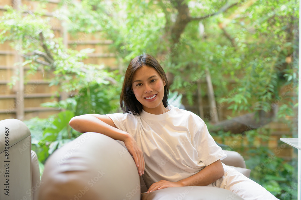 Young Thai Woman Smiling Indoors at Coffee Shop Young Thai Woman Smiling Indoors at Coffee Shop