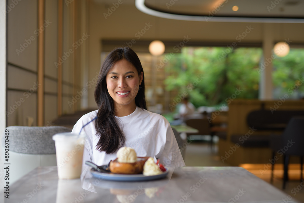 Young Thai Woman Enjoying Dessert at Coffee Shop Young Thai Woman Enjoying Dessert at Coffee Shop