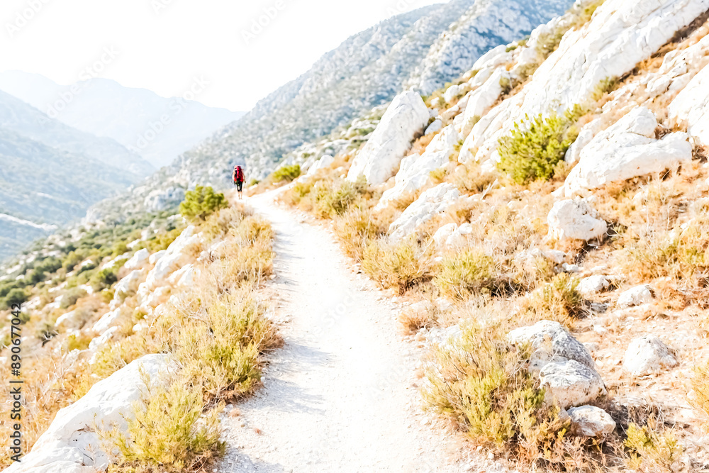 Solitary hiker on a mountain path Solitary hiker on a mountain path