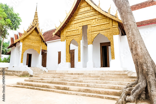 Ancient Temple with Golden Facade and Tree Roots photo