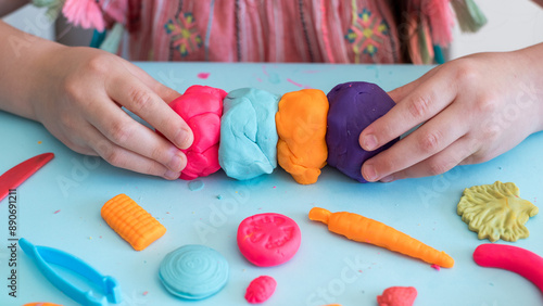 Colorful clay. Child's hands playing with colorful clay. Plasticine. play dough.