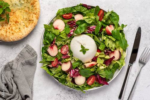 Food photography of salad with burrata and peaches; mozzarella, cheese; lettuce, radicchio, leaf, tomato; toast; garlic bread; oregano, pine nuts, pepper; seasoning,