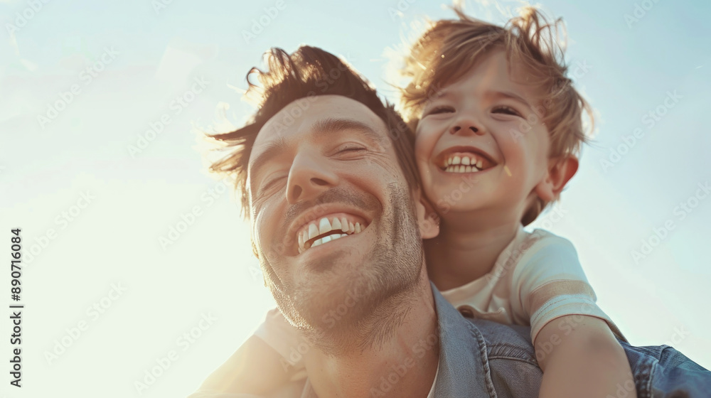 Joyful Father and Son Enjoying Quality Time Together Outdoors in the Sunlight Joyful Father and Son Enjoying Quality Time Together Outdoors in the Sunlight