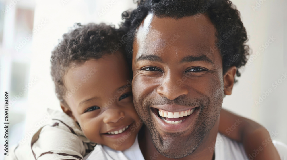 Joyful Father and Son Smiling Together in Bright Natural Light Indoors Joyful Father and Son Smiling Together in Bright Natural Light Indoors