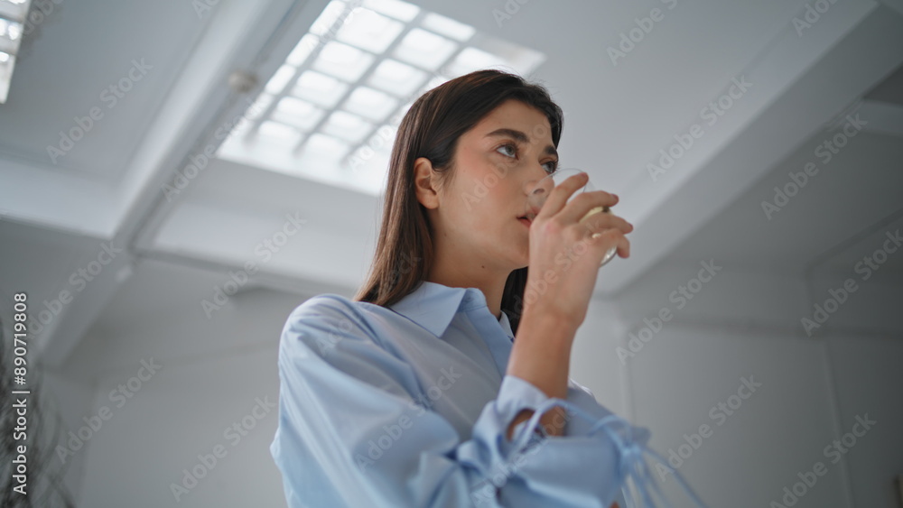 Pretty woman drinking water in office closeup. Beautiful girl taking break sip Pretty woman drinking water in office closeup. Beautiful girl taking break sip