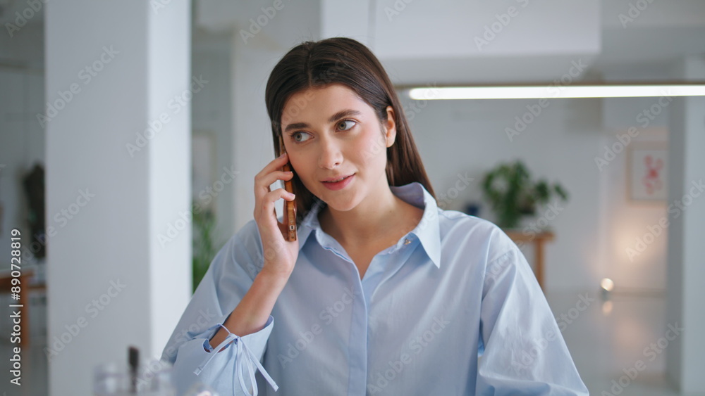 Young entrepreneur talking mobile phone closeup. Smiling woman working in office Young entrepreneur talking mobile phone closeup. Smiling woman working in office