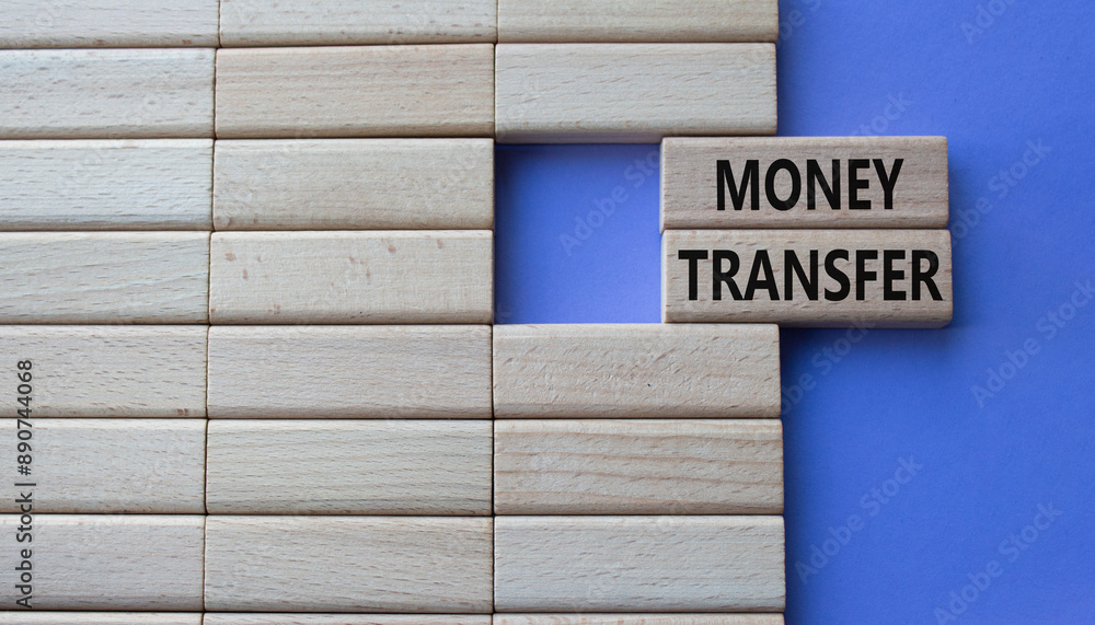 Money Transfer symbol. Concept word Money Transfer on wooden blocks. Beautiful purple background. Business and Money Transfer concept. Copy space Money Transfer symbol. Concept word Money Transfer on wooden blocks. Beautiful purple background. Business and Money Transfer concept. Copy space