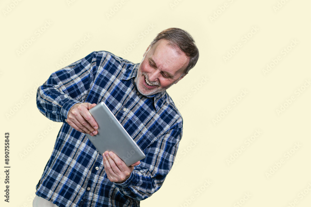 Happy expressive aged man playing video game on tablet pc. Isolated on white background. Happy expressive aged man playing video game on tablet pc. Isolated on white background.