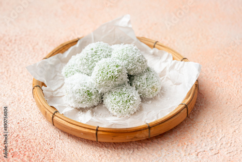 kelepon or klepon or onde-onde made from glutinous rice flour and filled with brownn sugar covered with grated coconut. photo