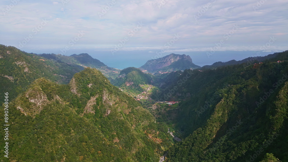 Obraz premium Green hillsides dense forests covering steep cliffs drone view. Scenic mountains