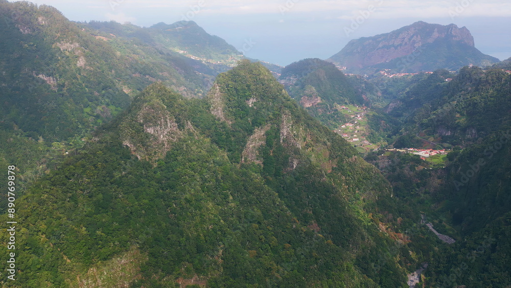 Naklejka premium Scenic green mountains rising over lush valleys in remote landscape drone view. 