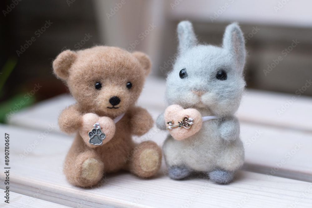Toy bear and rabbit on a bench Toy bear and rabbit on a bench