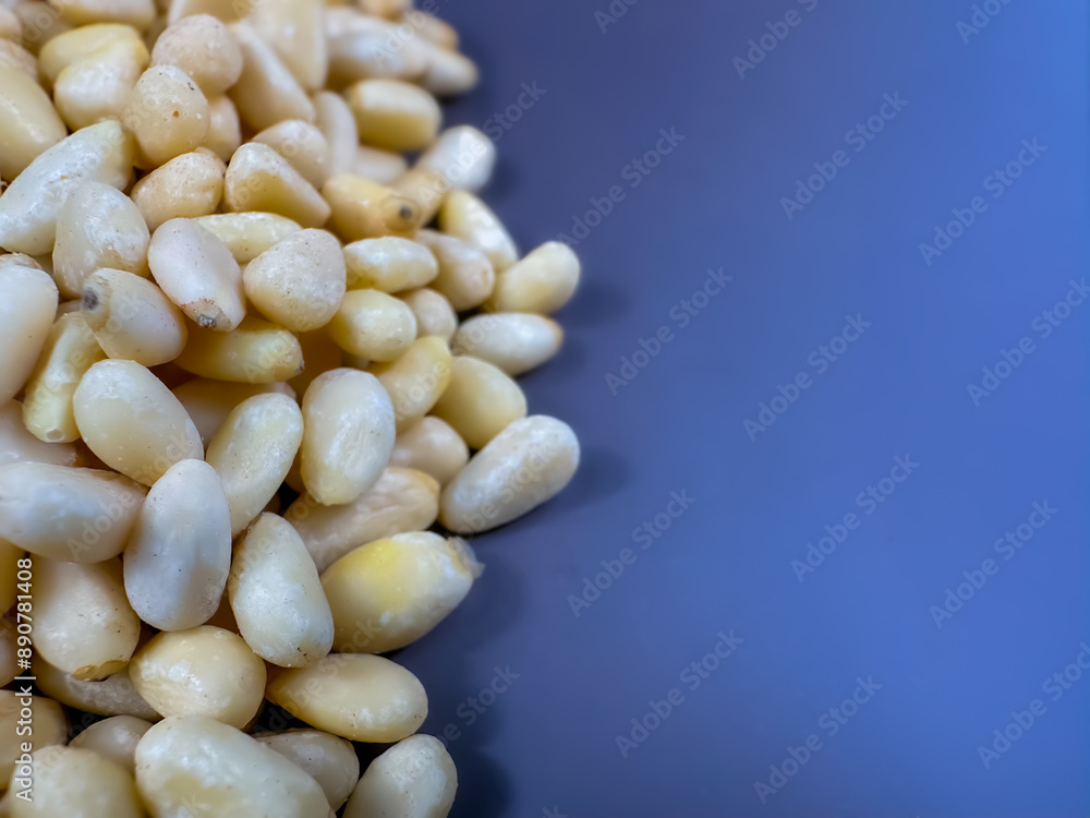 Background texture of shelled pine nuts and a gray-blue background. Background texture of shelled pine nuts and a gray-blue background.