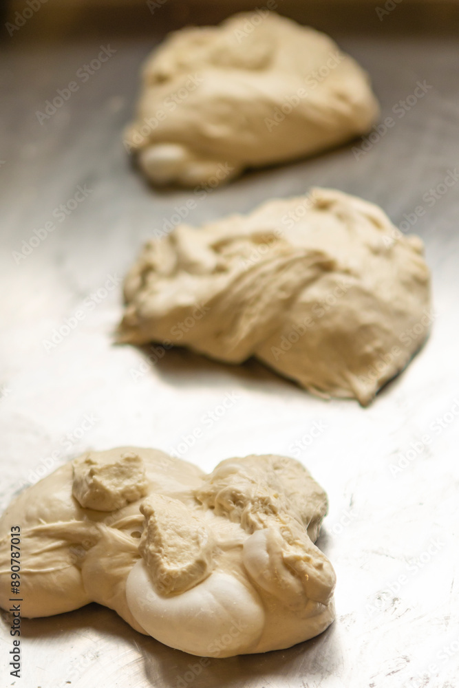Fresh pizza dough resting in a kitchen Fresh pizza dough resting in a kitchen