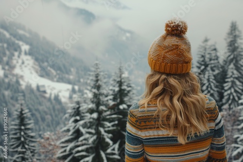 Woman Admires Snowy Mountain Range in Winter