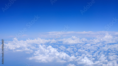 Horizontal gradient blue sky with white fluffy clouds