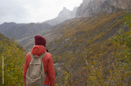Obraz na płótnie Brunette woman with a backpack on her back outdoors exploring the Caucasus Mountains in Russia, traveling, lifestyle, hiking, active autumn holidays, hiking w salonie