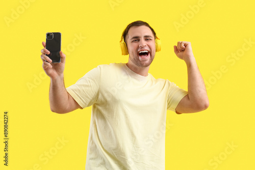 Happy young man with headph...