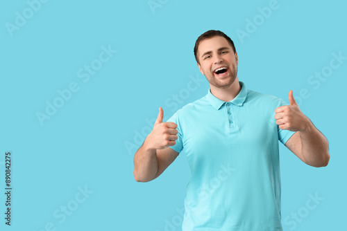 Happy young man showing thu...