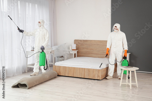 Male workers in hazmat suit...