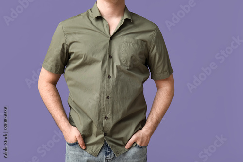 Young man in stylish green collar shirt on lilac background photo