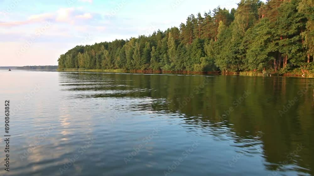 A body of water surrounded by trees A body of water surrounded by trees