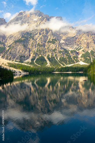 At Lake Braies in the morning on holiday in South Tyrol. A mountain in the Alps in the background