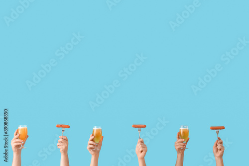 Many hands holding beer gla...