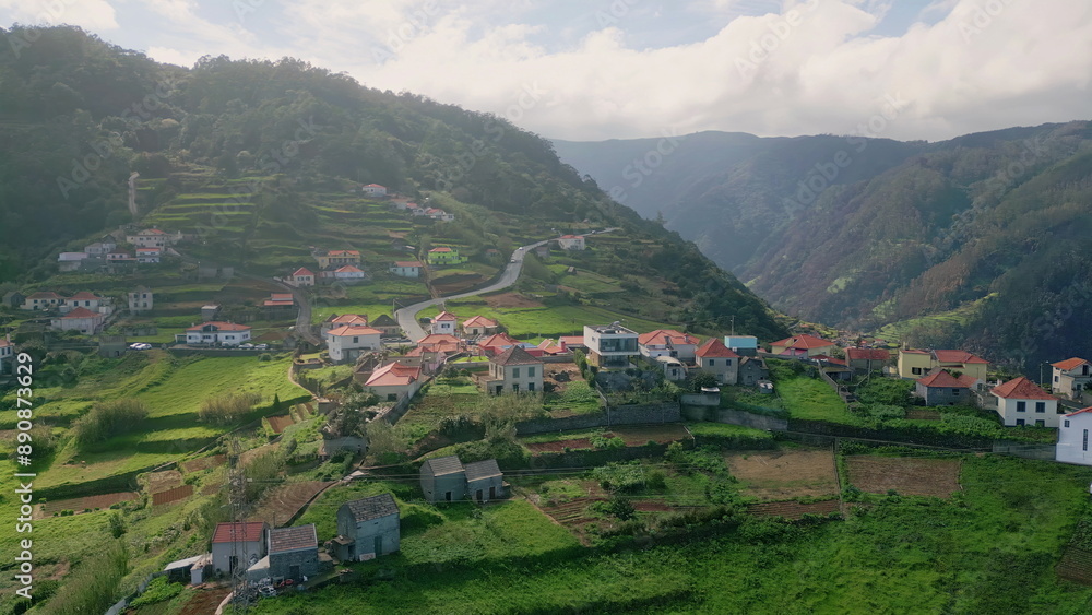 Fototapeta premium Portugal village placed mountain slopes with fields and winding roads aerial