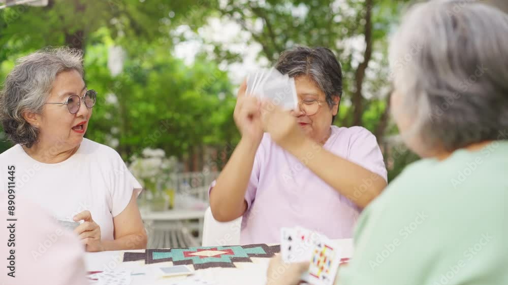 Group of Happy Asian senior mature women relax and enjoy indoor lifestyle meeting party together at home. Elderly retired woman friends having fun playing card together at home garden in summer day. Group of Happy Asian senior mature women relax and enjoy indoor lifestyle meeting party together at home. Elderly retired woman friends having fun playing card together at home garden in summer day.