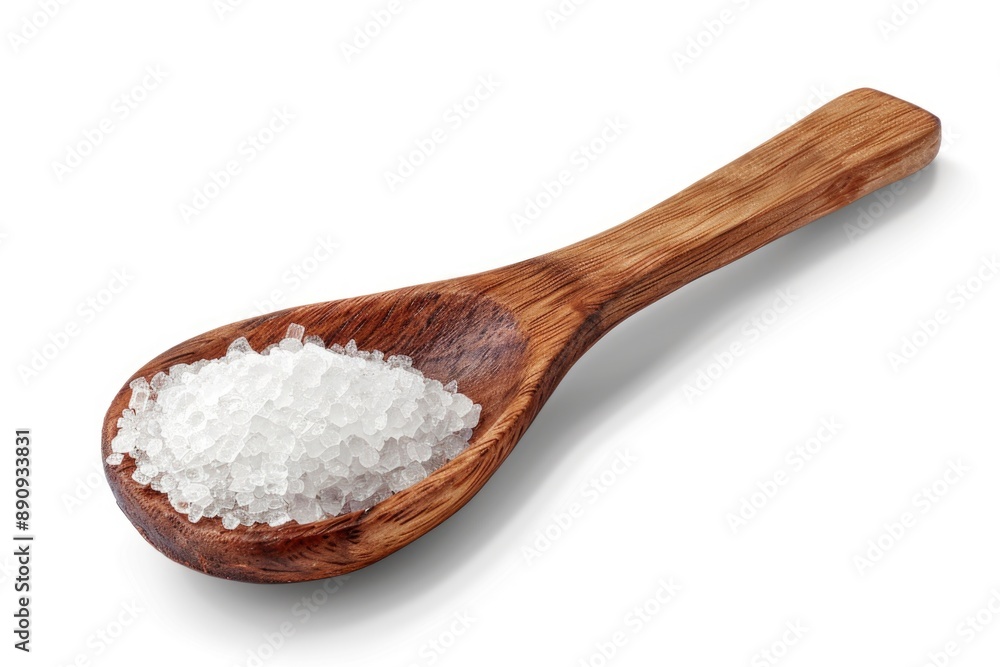 A wooden spoon filled with sea salt on a white surface, perfect for seasoning or decorative use A wooden spoon filled with sea salt on a white surface, perfect for seasoning or decorative use
