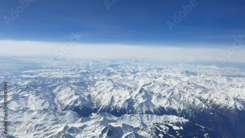 Airplane window view flying over the Alps
