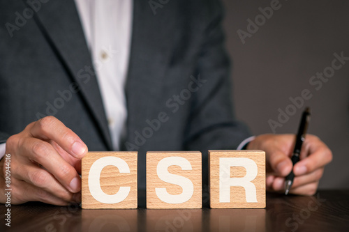 There is wood cube with the word CSR. It is an abbreviation for Corporate Social Responsibility as eye-catching image.