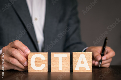 There is wood cube with the word CTA. It is an abbreviation for Call To Action as eye-catching image.