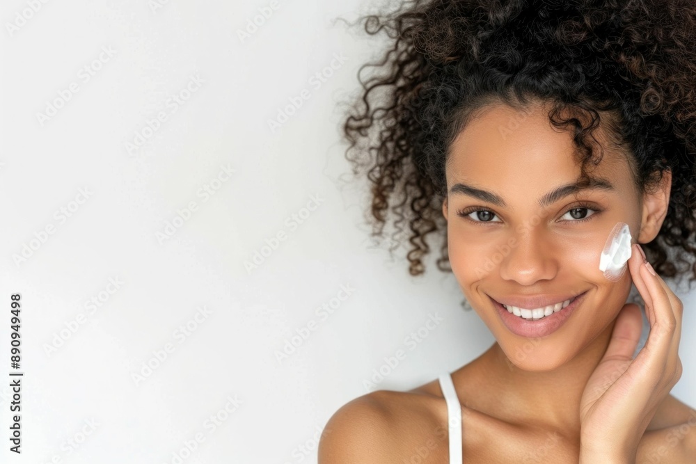 Happy African American Woman with Curly Hair Holding Cream on Face Smiling, Beauty and Skincare Concept Happy African American Woman with Curly Hair Holding Cream on Face Smiling, Beauty and Skincare Concept