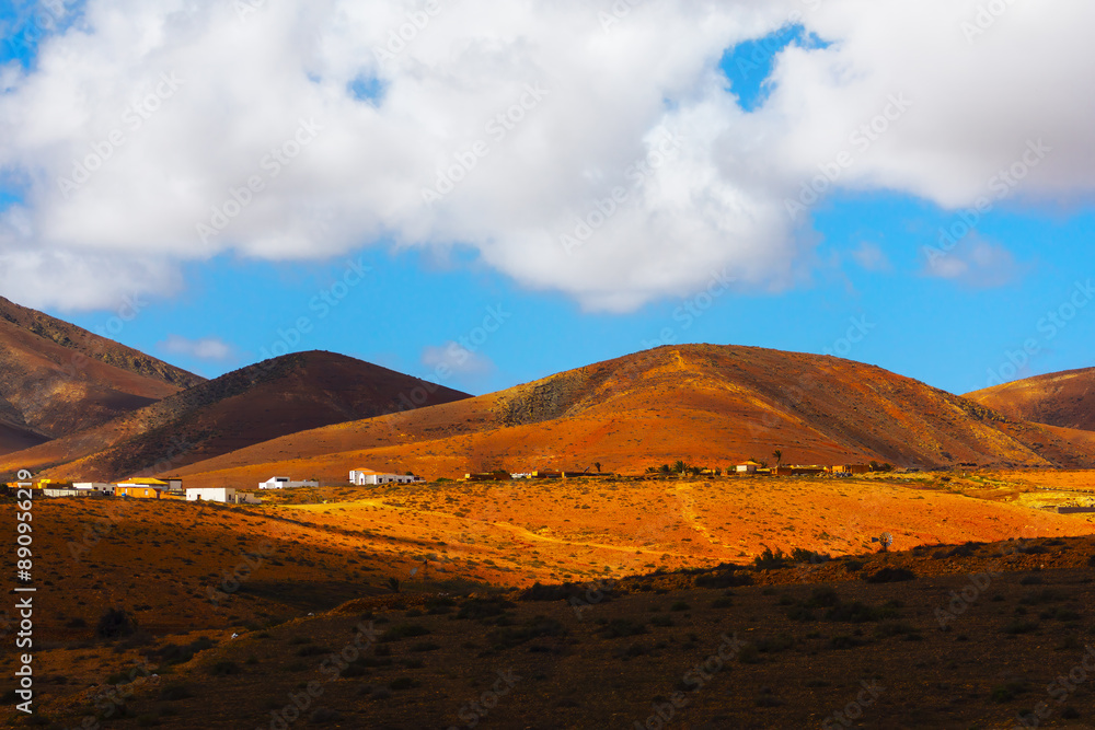 Village on the Island of Fuerteventura, Canary Islands, Spain. Beautiful landscape with a few houses on the side of a hill on the island Village on the Island of Fuerteventura, Canary Islands, Spain. Beautiful landscape with a few houses on the side of a hill on the island