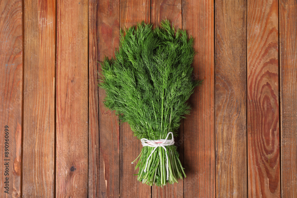 Bunch of fresh green dill on wooden table, top view Bunch of fresh green dill on wooden table, top view