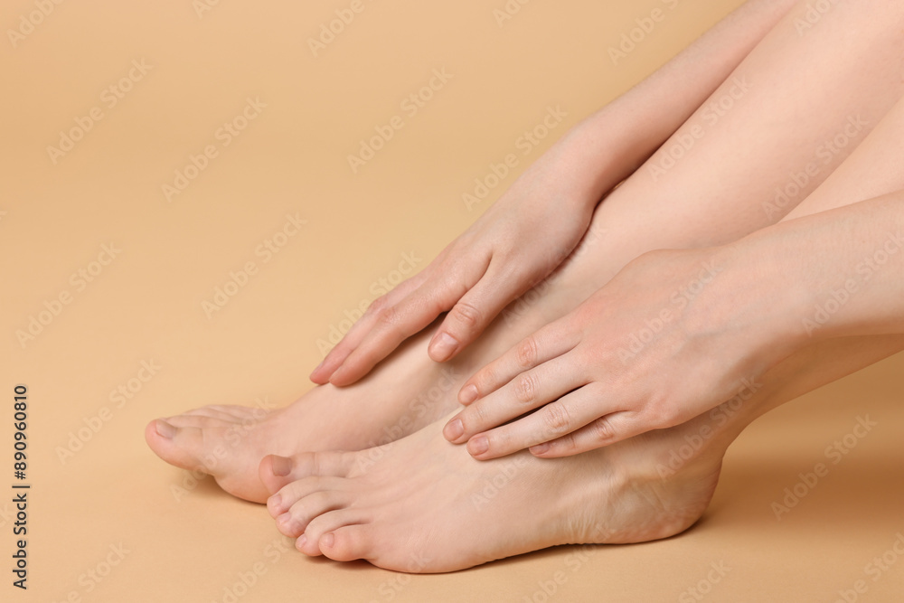 Closeup view of woman`s groomed feet after care procedure on beige background Closeup view of woman`s groomed feet after care procedure on beige background