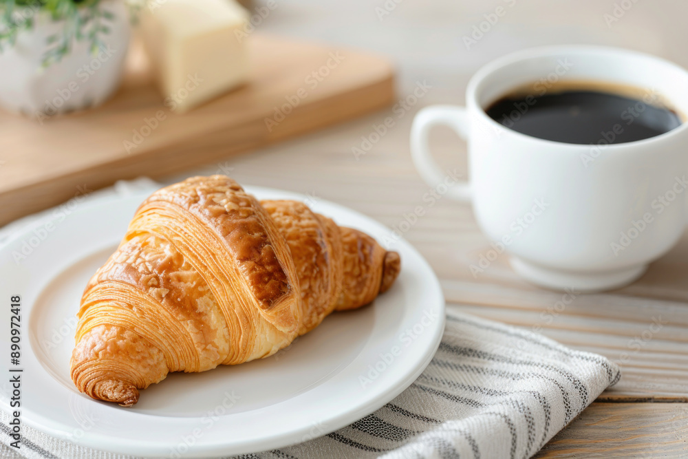 A cup of black coffee and croissant on table at hotel restaurant cafe A cup of black coffee and croissant on table at hotel restaurant cafe
