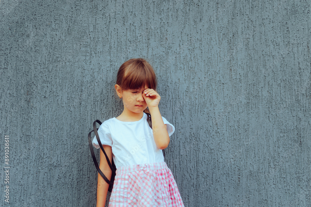 Fototapeta premium Unhappy Girl Crying Because of Going Back to School. Frustrated schoolgirl feeling emotional and distressed 