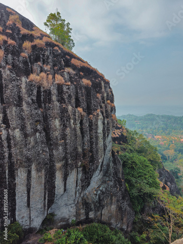 Detail of the rocks of the Nglanggeran Ancient Volcano ecotourism area in Yogyakarta, Indonesia during the day from one of its peaks. One corner of a very large ancient rock mountain photo