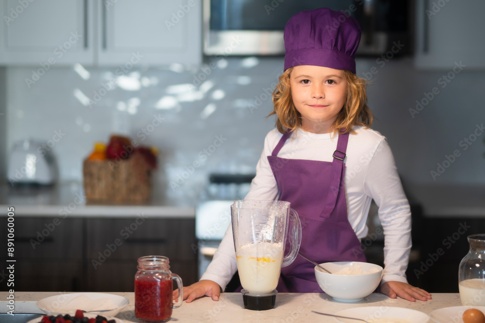 Child 7-8 years old in chef hat and apron. Chef kid cook baking at home kitchen. Child 7-8 years old in chef hat and apron. Chef kid cook baking at home kitchen.