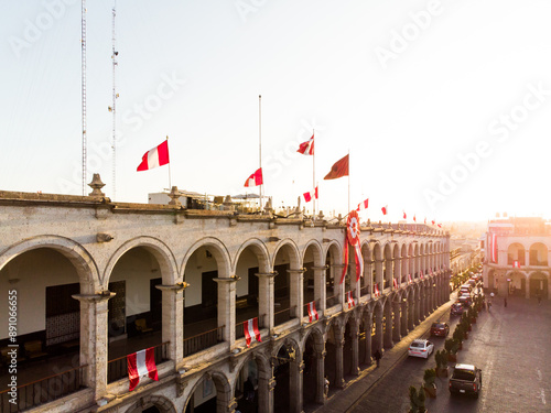 Portales de la plaza principal de Arequipa en el atardecer con las banderas del Perú en el mes de Julio  photo