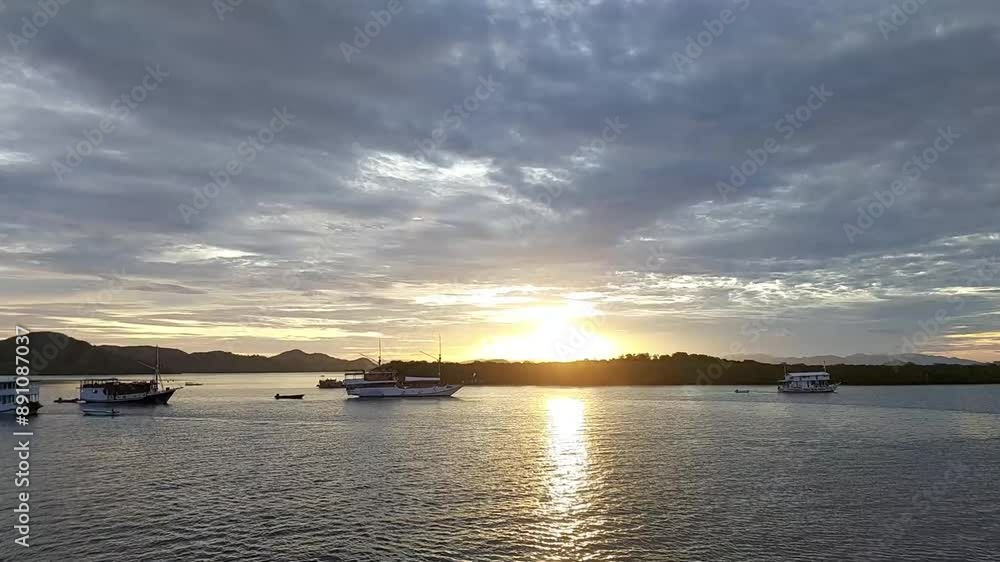 Serene Sunset Over Calm Waters at Labuan Bajo Serene Sunset Over Calm Waters at Labuan Bajo