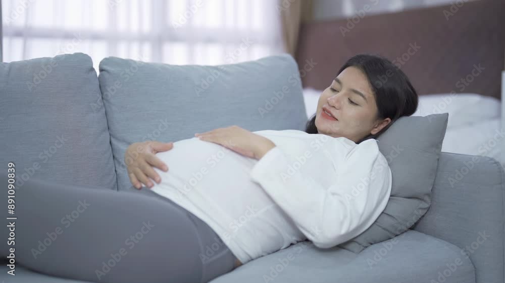 A Portrait of happy Asian pregnant woman in bedroom at home. Having a baby. Family people lifestyle. Love. A Portrait of happy Asian pregnant woman in bedroom at home. Having a baby. Family people lifestyle. Love.