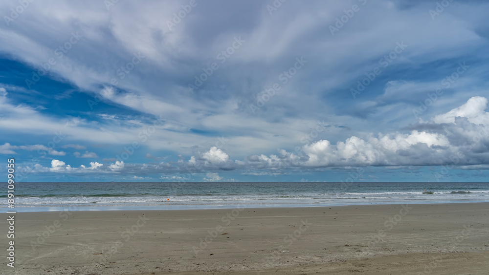 Beautiful sea and sky scenery. Turquoise ocean waves foam and spread over the sandy beach. Picturesque cumulus and cirrus clouds in the blue sky. Malaysia. Borneo. Kota Kinabalu Beautiful sea and sky scenery. Turquoise ocean waves foam and spread over the sandy beach. Picturesque cumulus and cirrus clouds in the blue sky. Malaysia. Borneo. Kota Kinabalu
