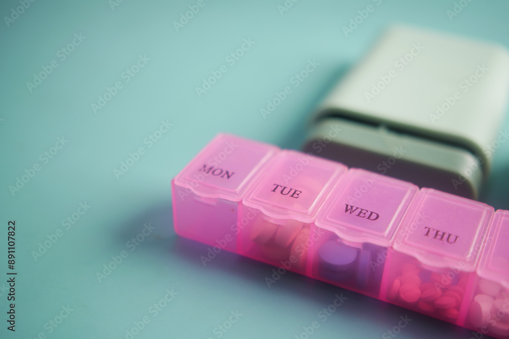 close up of medical pills in a pill box on table close up of medical pills in a pill box on table