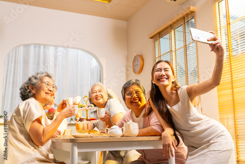 Canvas Print Group of Happy Asian senior women having meeting party afternoon tea at home