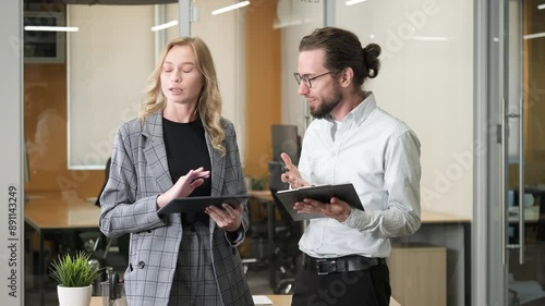 Two professional having an argument comparing their ideas. Businesswoman shaking her head and making hand gestures about not agreeing of what her officemate suggested about work.