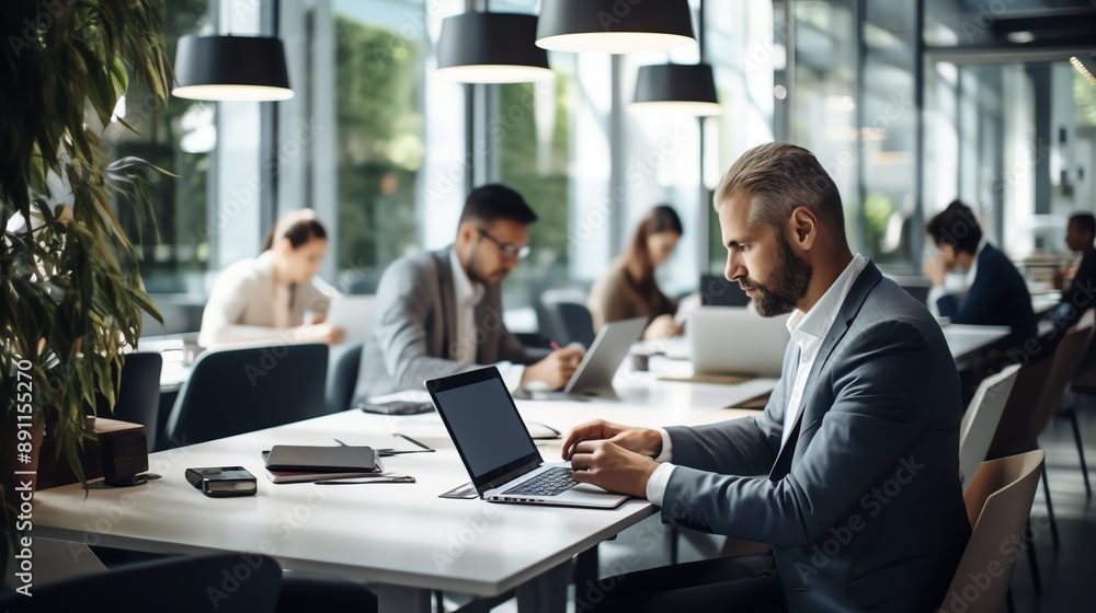 A high-resolution photo of a business team working on laptops in a clean, modern workspace, collaborative and professional. A high-resolution photo of a business team working on laptops in a clean, modern workspace, collaborative and professional.